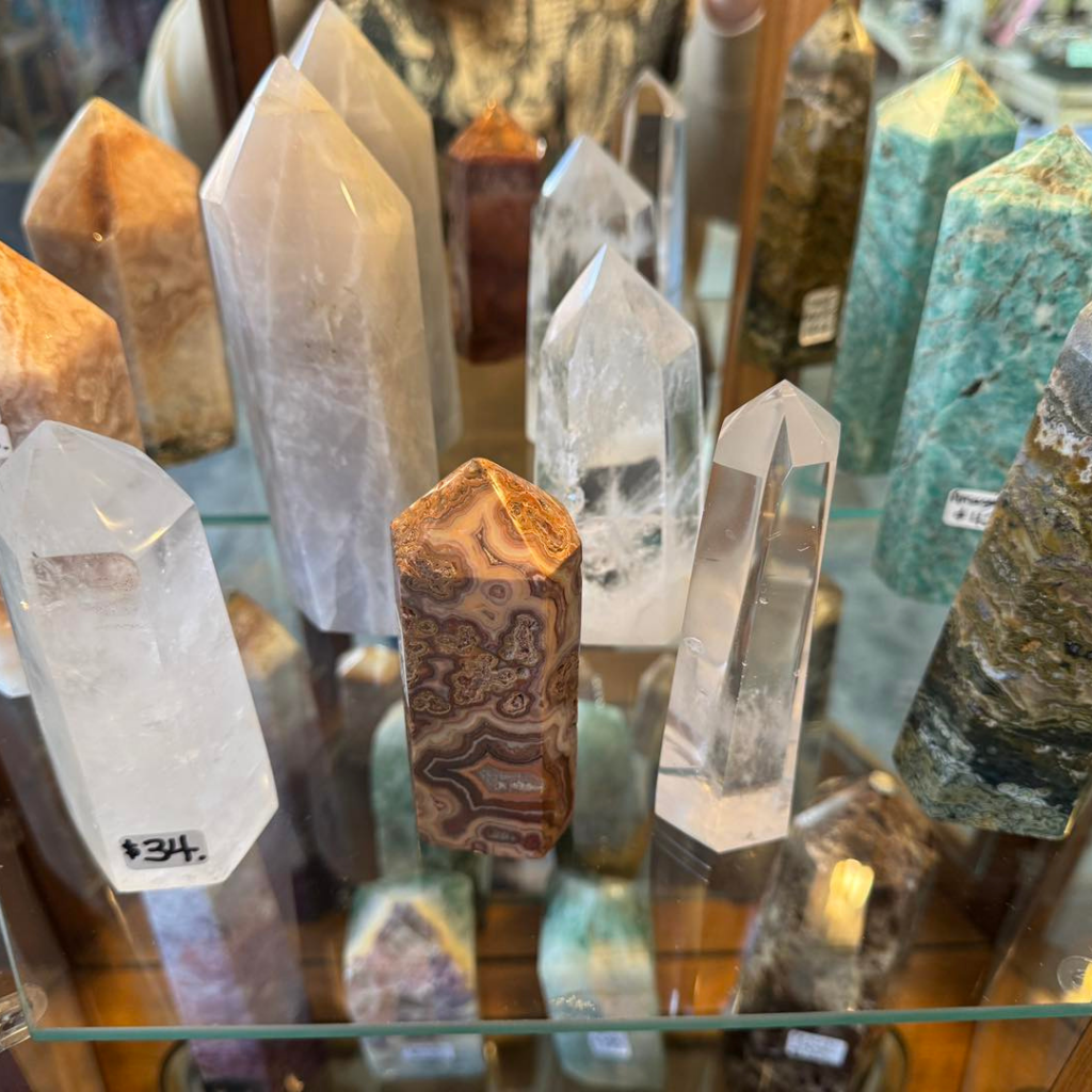 Display of polished crystal towers and gemstone points in various colors inside Molly Roberts Studio.