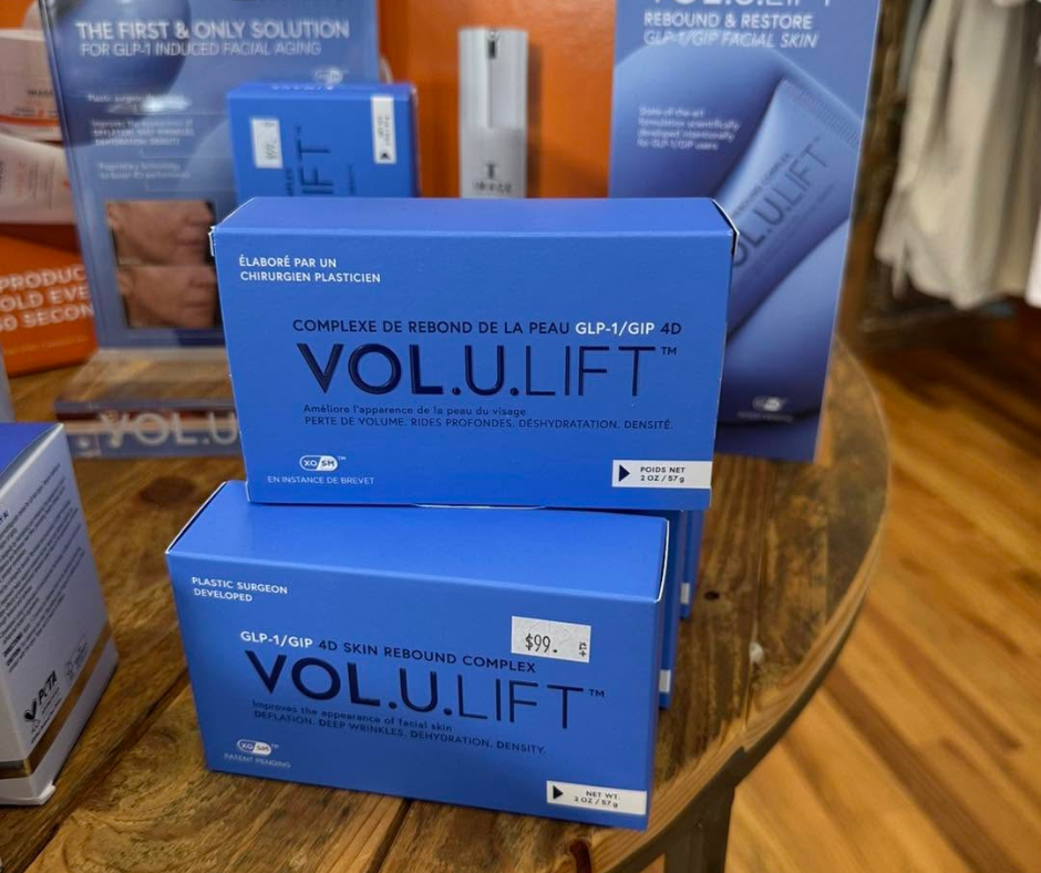 Display of Volulift skincare products in blue packaging arranged on a tabletop inside a spa or beauty boutique.