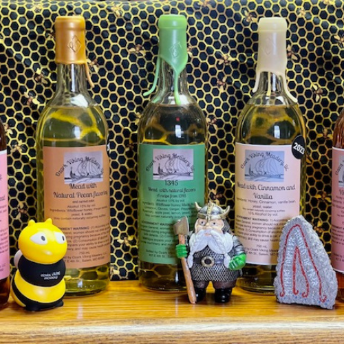 Ozark Viking Meadery bottles of mead including natural, spiced, and cinnamon vanilla flavors displayed on a shelf