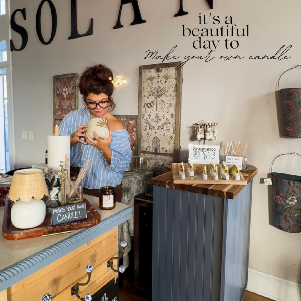 Woman smelling a candle at a candle-making station inside Solana boutique in downtown Excelsior Springs.