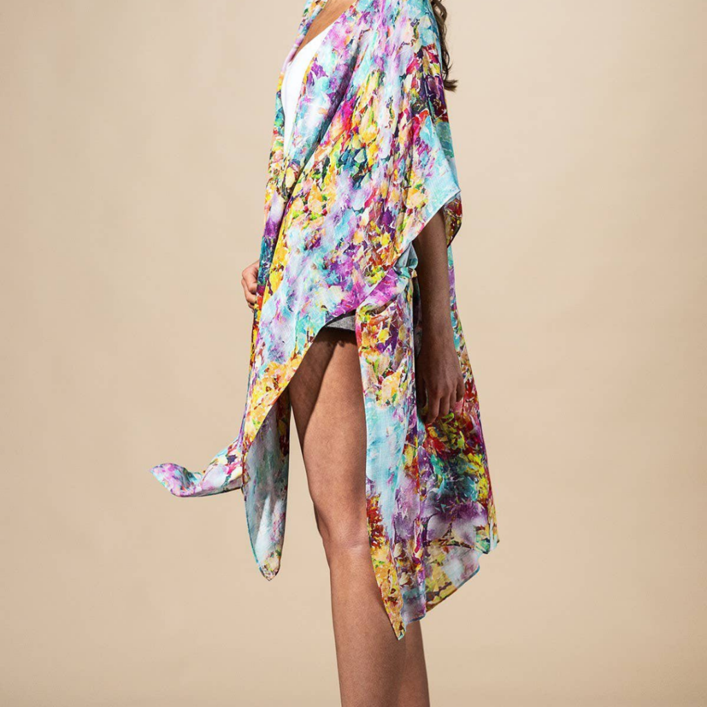 Colorful floral kimono-style wrap with flowing fabric displayed at Three Birdies Boutique in downtown Excelsior Springs.