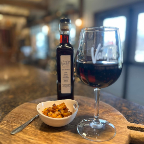 Glass of red wine and small food pairing at Van Till Family Farm Winery tasting room in Missouri