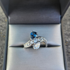 Stacked diamond and gold bands with round diamonds set in white and yellow gold, displayed on soft pink fabric.