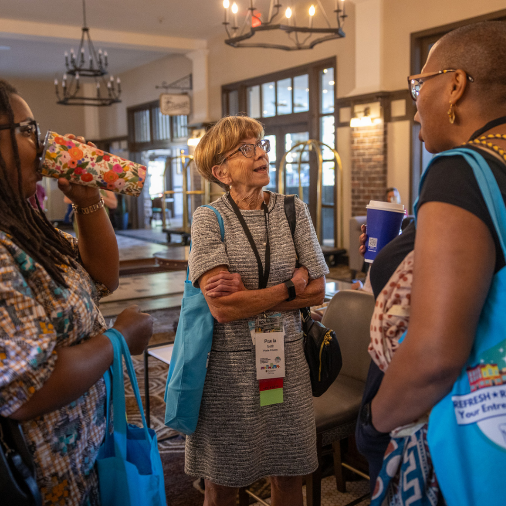 Conference attendees network and exchange ideas in the lobby of The Elms Hotel & Spa during the Connecting Entrepreneurial Communities Conference in Excelsior Springs.