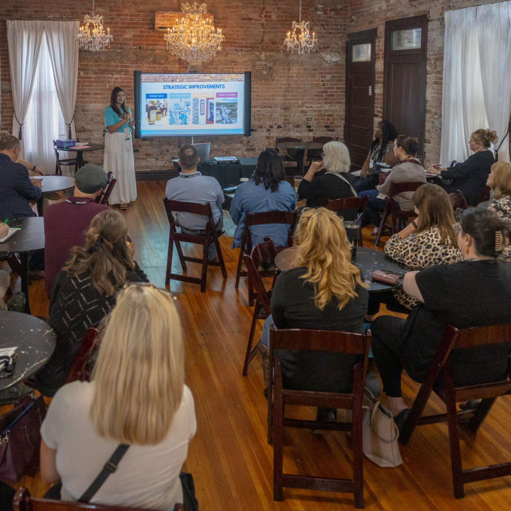 A presenter leads a downtown revitalization workshop during the Connecting Entrepreneurial Communities Conference, sharing strategies for community development and economic growth.