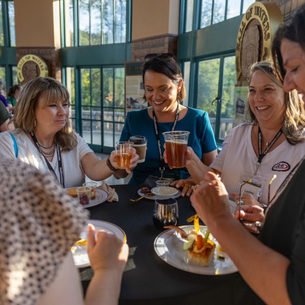 Conference attendees enjoy local food and beverages while networking inside the historic Hall of Waters during the Connecting Entrepreneurial Communities Conference.
