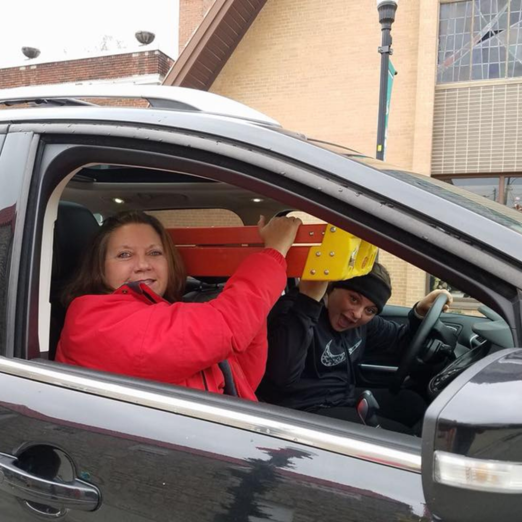 Carol Baxter transports holiday decorating supplies through Downtown Excelsior Springs while helping prepare seasonal displays and community events.