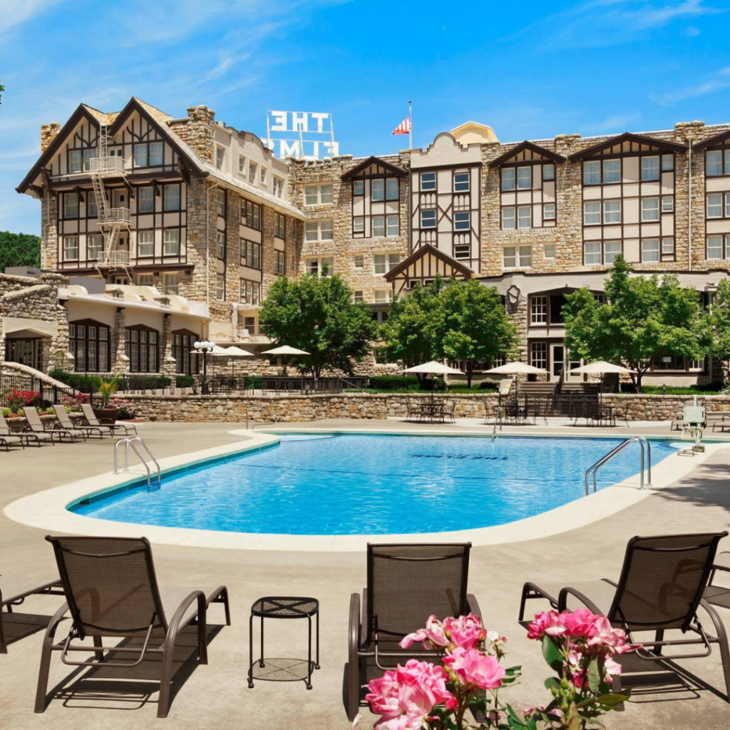 The Elms Hotel & Spa overlooks its outdoor pool and courtyard, showcasing the historic resort's luxury accommodations and amenities in Excelsior Springs.