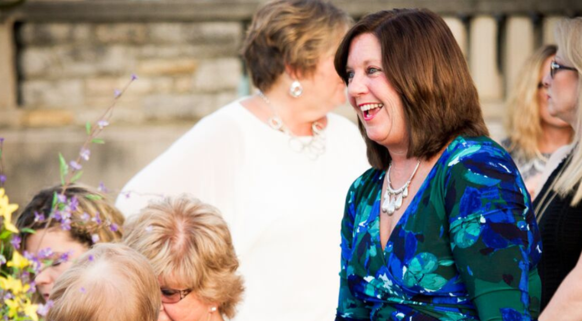 Carol Baxter smiles while attending a Downtown Excelsior Partnership event. A longtime volunteer, business owner, and advocate, she has dedicated more than 15 years to revitalizing Downtown Excelsior Springs.