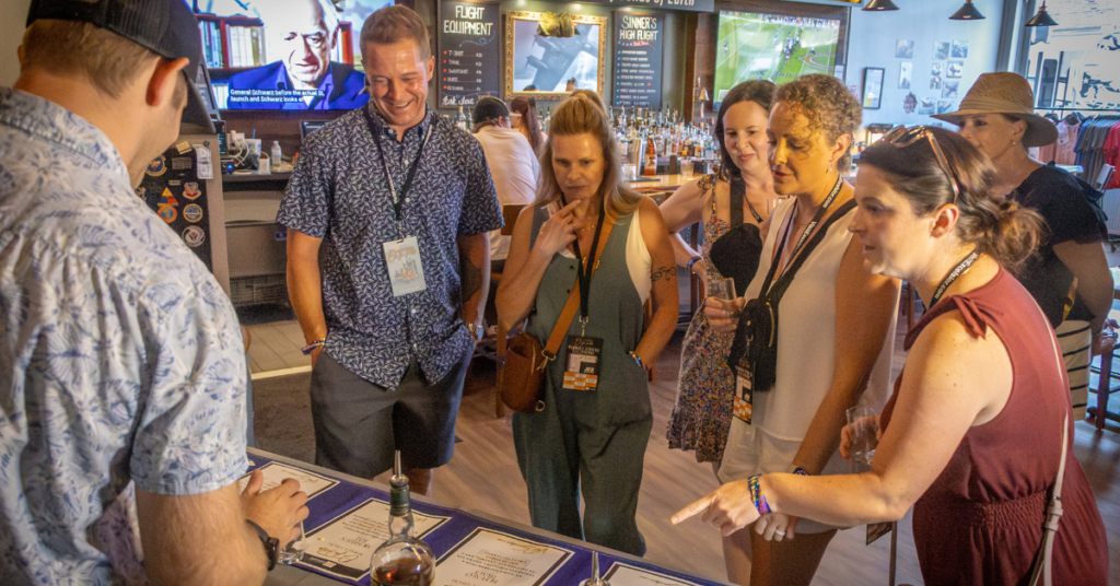 Guests sampling whiskey during the On The Rocks Whiskey Stroll in Downtown Excelsior Springs.