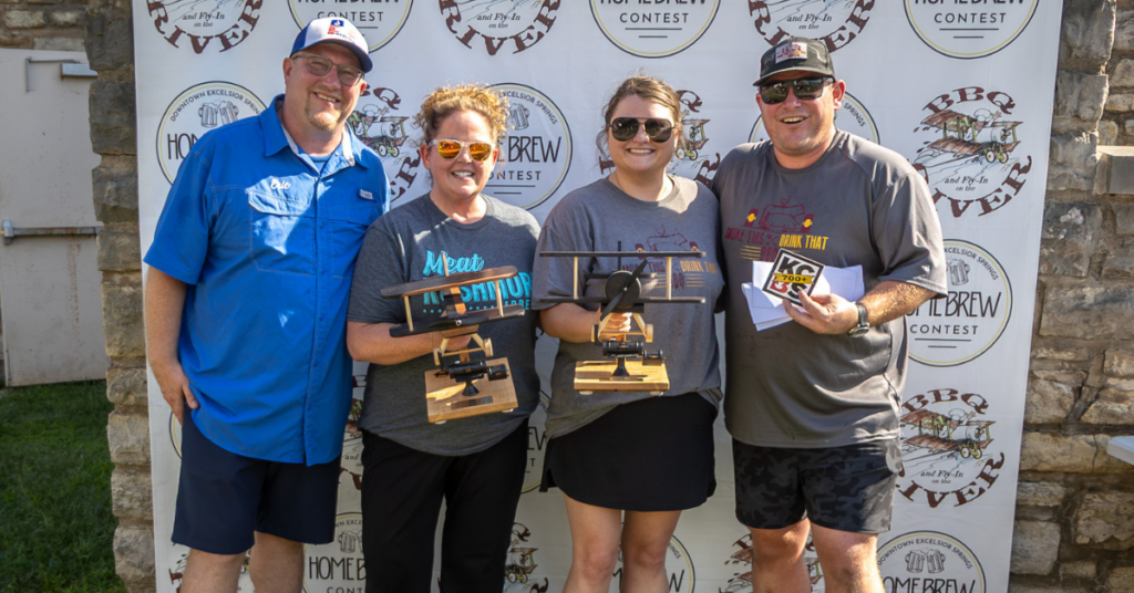 winners celebrating with their awards at the BBQ & Fly-In on the River.