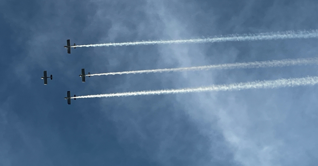 Four airplanes performing a formation flyover above the BBQ & Fly-In on the River in Excelsior Springs.
